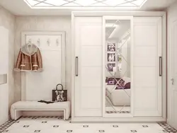 White wardrobe in the hallway with a mirror photo