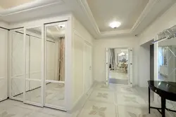 White wardrobe in the hallway with a mirror photo