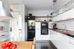 Black Refrigerator In A White Kitchen In The Interior Photo