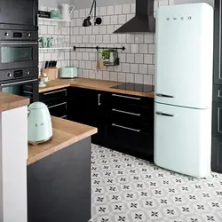 Black refrigerator in a white kitchen in the interior photo