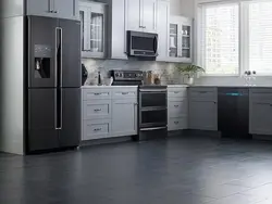 Black refrigerator in a white kitchen in the interior photo