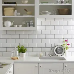 Kitchen apron made of white brick tiles photo