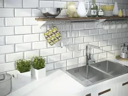 Kitchen apron made of white brick tiles photo