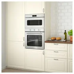 Photo of a kitchen with a pencil case for an oven and microwave