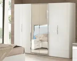 Wardrobe with hinged doors and mirror in the bedroom photo