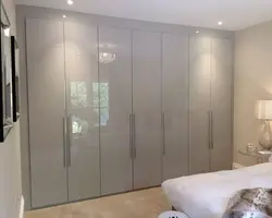 Wardrobe with hinged doors and mirror in the bedroom photo
