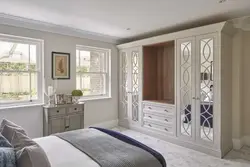 Wardrobe with hinged doors and mirror in the bedroom photo