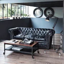 Black sofa in the kitchen interior