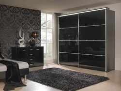 Black wardrobe in the bedroom interior