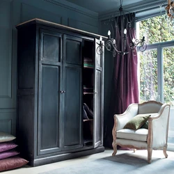 Black wardrobe in the bedroom interior