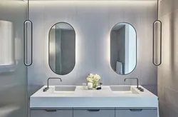 Oval mirror in the bathroom interior