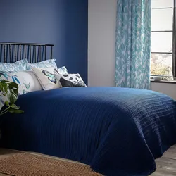 Blue bedspread in the bedroom interior