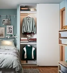 Narrow wardrobe in the bedroom interior