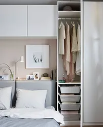 Narrow wardrobe in the bedroom interior