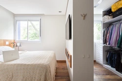Narrow wardrobe in the bedroom interior