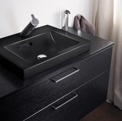 Black cabinet in the bathroom interior