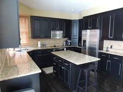 Dark walls, light kitchen in the interior