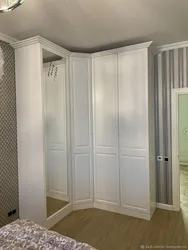 White corner wardrobe in the bedroom interior