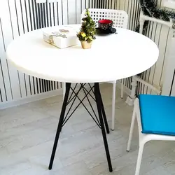 Table with black legs in the kitchen interior
