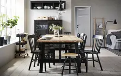 Table with black legs in the kitchen interior