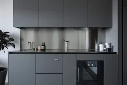 Gray kitchen with black handles in the interior