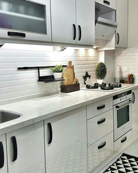 Gray kitchen with black handles in the interior