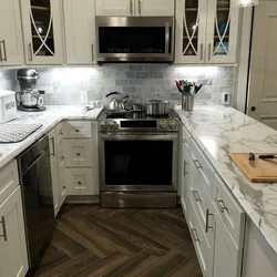 Gray kitchen in the interior with marble countertops