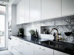 Gray kitchen in the interior with marble countertops