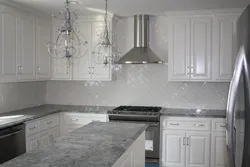 Gray kitchen in the interior with marble countertops