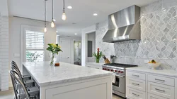 Gray kitchen in the interior with marble countertops