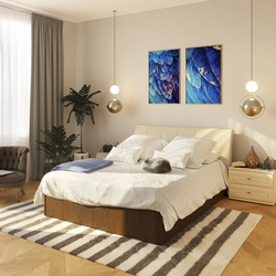 Beige bed with a soft headboard in the bedroom interior