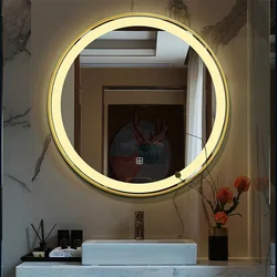 Round mirror with lighting in the bathroom in the interior