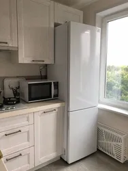 Direct kitchen design with a refrigerator by the window