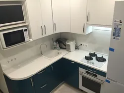 Corner kitchen design with refrigerator and microwave