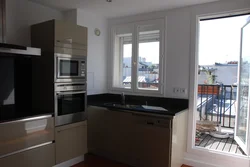Kitchen design with a refrigerator in the corner by the window