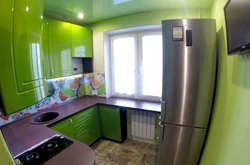Kitchen design with a refrigerator in the corner by the window