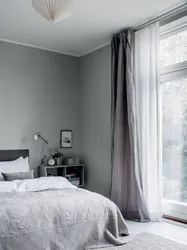Bedroom design with white wallpaper and gray curtains