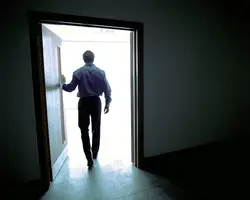 Photo of someone standing against the wall of an apartment