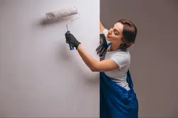Photo of someone standing against the wall of an apartment