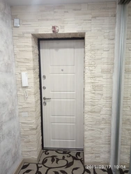 Stone decoration of the entrance door in the apartment photo