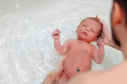 Photo of a newborn in the bath