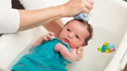 Photo of a newborn in the bath