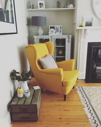 Yellow armchair in the bedroom interior