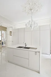 White kitchen design with marble countertops