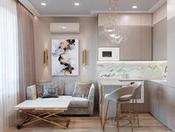 Kitchen design in a one-room apartment with a sofa