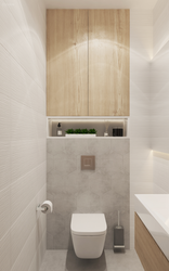 Design of a toilet in an apartment with a cabinet and tiles