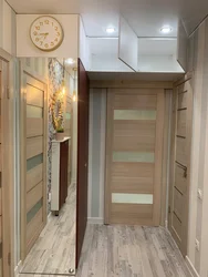 Hallway cabinet design opposite the door