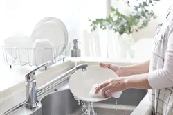 Washing dishes in the kitchen photo