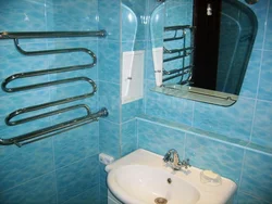Photo of bathtub tiles and pipes
