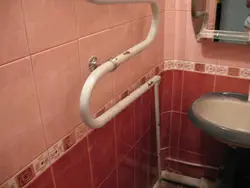 Photo of bathtub tiles and pipes